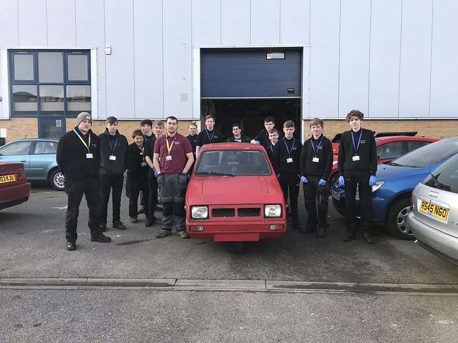 Students helping to get three-wheeler ready for Pavestone Rally