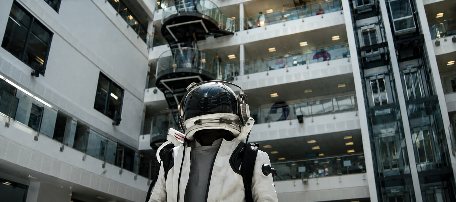 The astronaut character inside a modern building during filming
